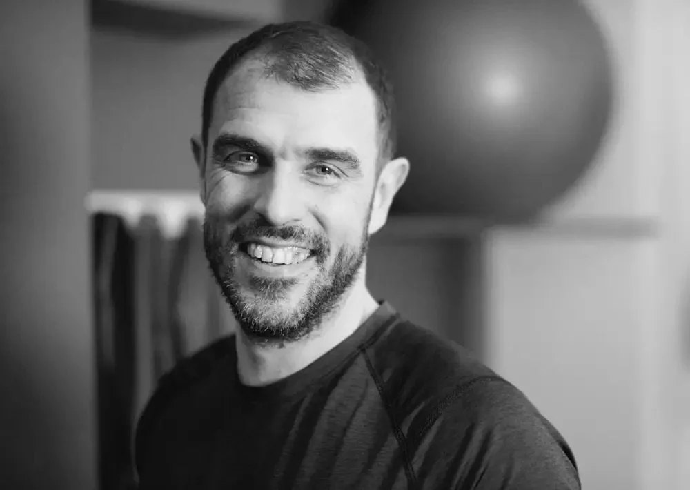 Matthew Cumming smiling to camera in his Seven Dials studio